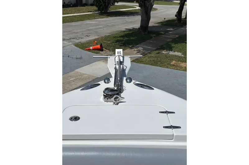 Slide: The Image of Bow view of a 2011 Sea Hunt Gamefish 25 boat, parked on a driveway. - 6