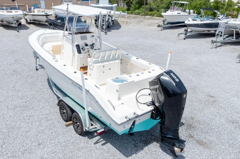 Slide: The Image of 2022 Cobia 237 Center Console boat with Mercury engine on trailer in a boatyard. - 12