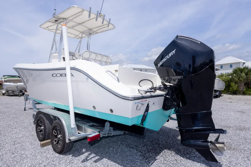 Slide: The Image of 2022 Cobia 237 Center Console boat with Mercury engine on trailer, parked outdoors. - 15