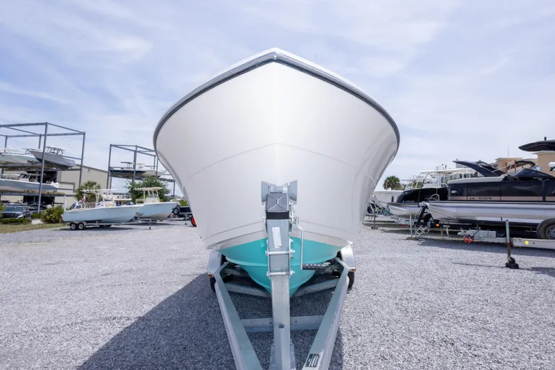Slide: The Image of 2022 Cobia 237 Center Console boat on trailer in a marina setting. - 19