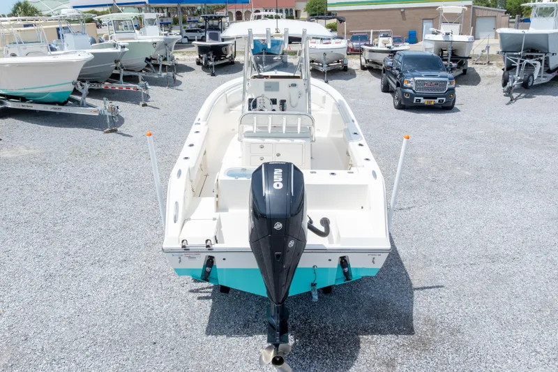 Slide: The Image of 2022 Cobia 237 Center Console boat with powerful outboard motor in urban setting. - 21