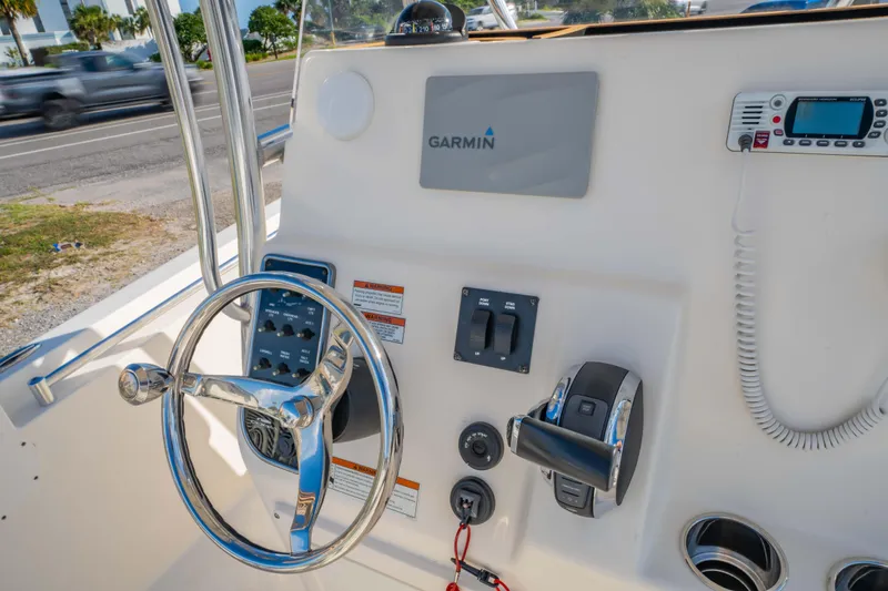 Slide: The Image of 2022 Cobia 237 Center Console boat dashboard with Garmin navigation system and controls. - 28
