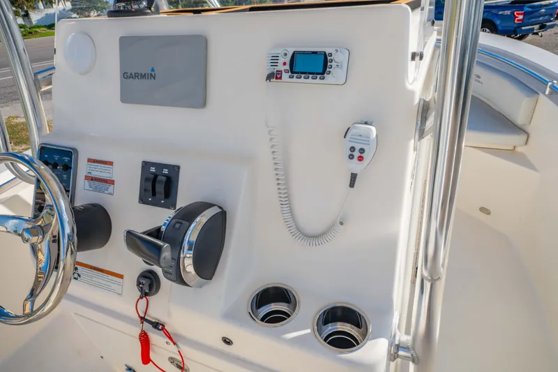 Slide: The Image of 2022 Cobia 237 Center Console boat dashboard with Garmin navigation and control panel. - 29