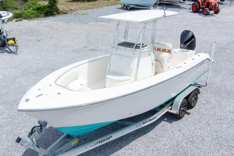Slide: The Image of 2022 Cobia 237 Center Console boat on trailer, parked outdoors, side view. - 3