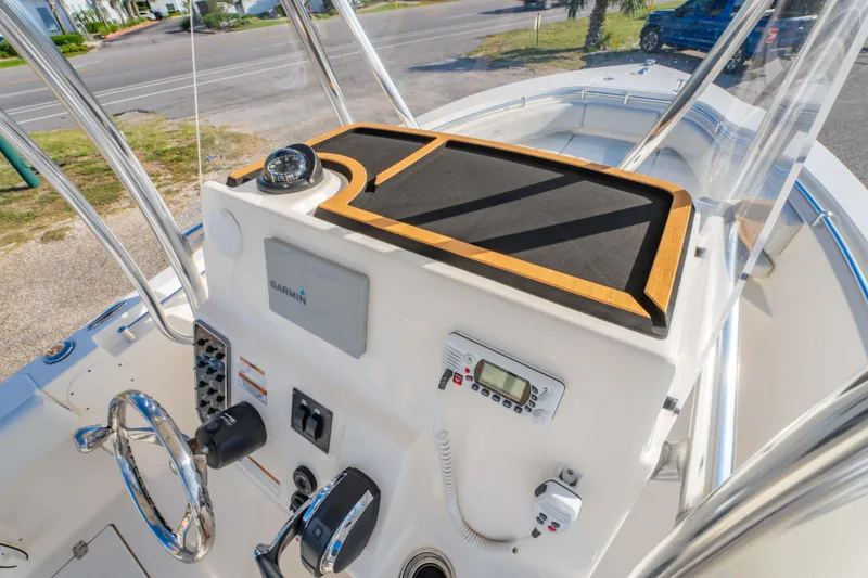 Slide: The Image of 2022 Cobia 237 Center Console boat dashboard with Garmin navigation system and steering wheel. - 30