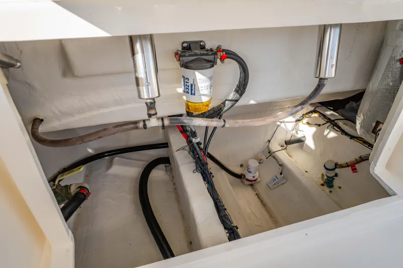 Slide: The Image of 2022 Cobia 237 Center Console boat interior showing wiring and fuel system components. - 38
