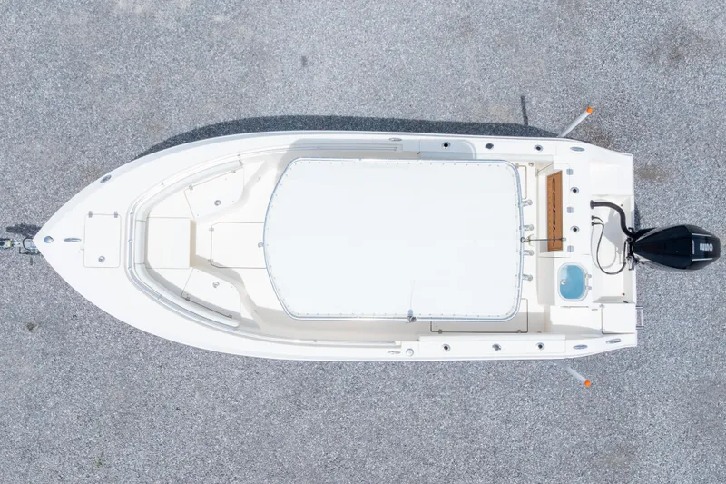 Slide: The Image of 2022 Cobia 237 Center Console boat on trailer, urban background. - 4
