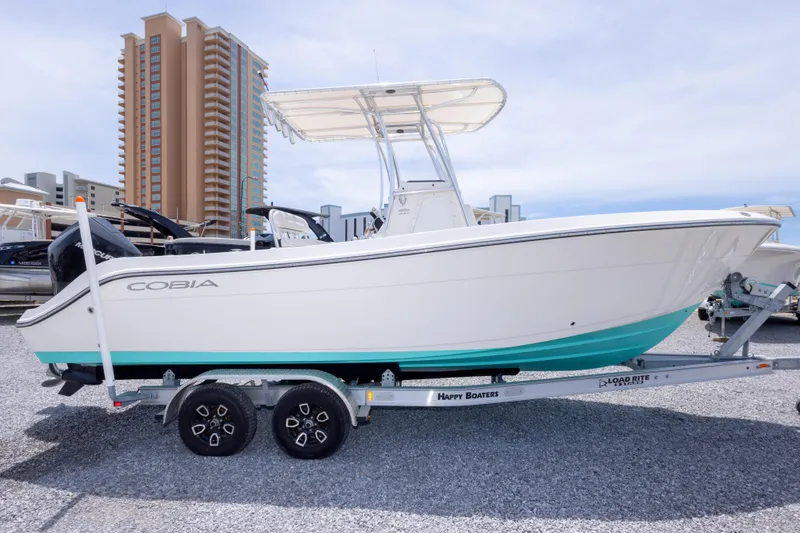 Slide: The Image of 2022 Cobia 237 Center Console boat on gravel lot, viewed from the front. - 9