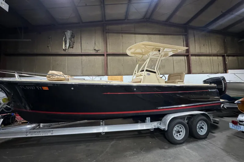 The Image of 2020 Vanquish Runabout boat on trailer in indoor storage facility. - 1