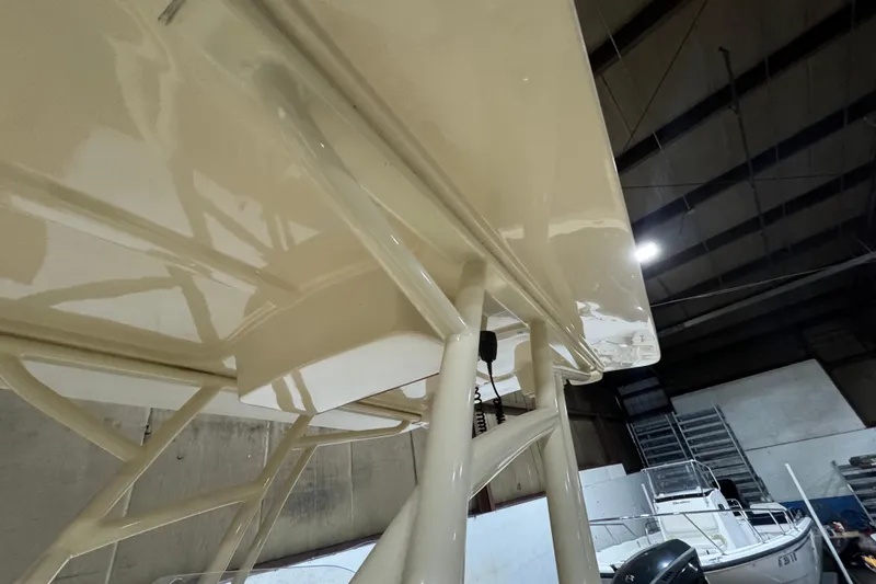 Slide: The Image of 2020 Vanquish Runabout boat interior, showcasing sleek design and structure in a warehouse setting. - 11