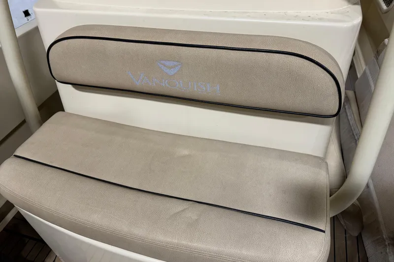 Slide: The Image of Vanquish Runabout 2020 boat seat with beige upholstery and logo embroidery. - 12