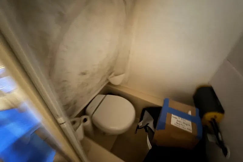 Slide: The Image of Compact bathroom in 2020 Vanquish Runabout with toilet and storage items. - 14