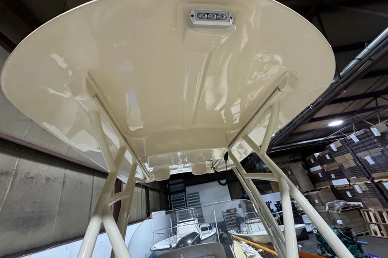 Slide: The Image of 2020 Vanquish Runabout boat underside view in a warehouse setting. - 15
