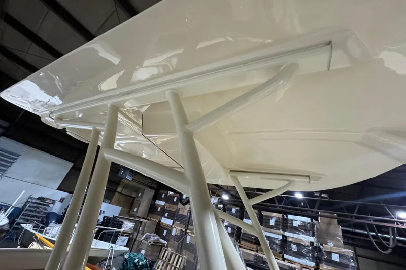 Slide: The Image of 2020 Vanquish Runabout boat structure in warehouse, showcasing sleek design and sturdy build. - 16