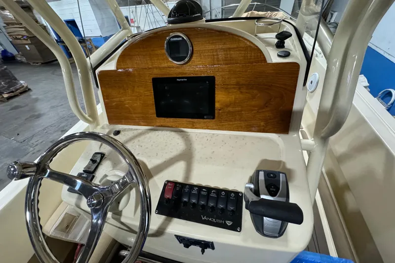 Slide: The Image of 2020 Vanquish Runabout boat dashboard with steering wheel and control panel. - 17