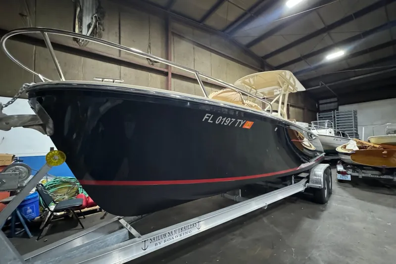 Slide: The Image of 2020 Vanquish Runabout boat on trailer in warehouse setting. - 5