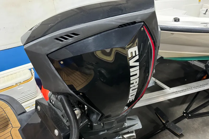 Slide: The Image of Evinrude outboard motor on a 2020 Vanquish Runabout boat in a showroom. - 6