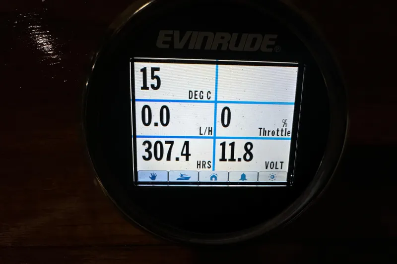 Slide: The Image of Evinrude digital display showing temperature, throttle, hours, and voltage on 2020 Vanquish Runabout. - 7