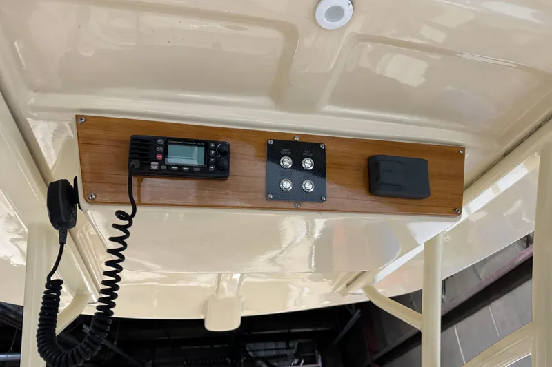 Slide: The Image of 2020 Vanquish Runabout boat dashboard with radio and control panel. - 9
