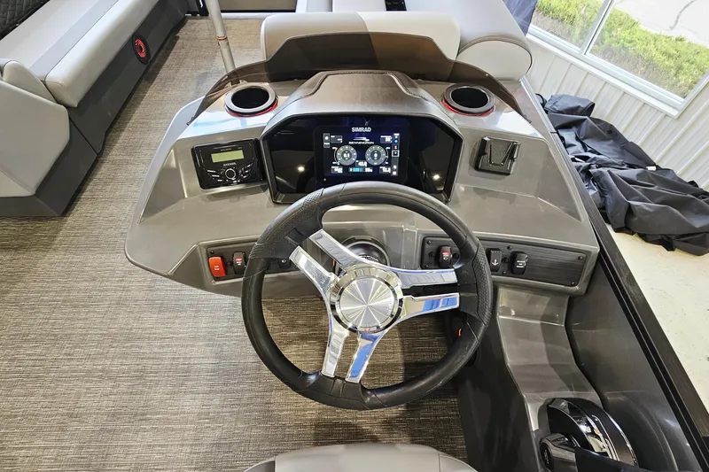 Slide: The Image of 2024 Bennington 22 S Swingback boat dashboard with steering wheel and digital display. - 11
