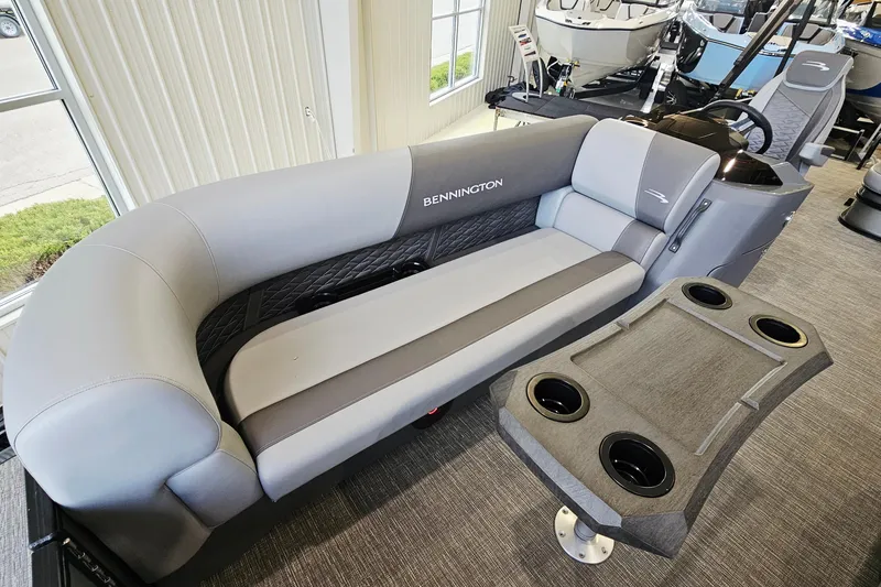 Slide: The Image of 2024 Bennington 22 S Swingback pontoon boat interior with plush seating and cup holders. - 13