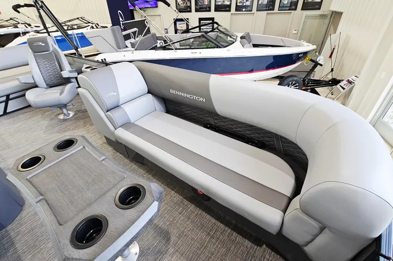 Slide: The Image of 2024 Bennington 22 S Swingback boat interior with plush seating and cup holders. - 14