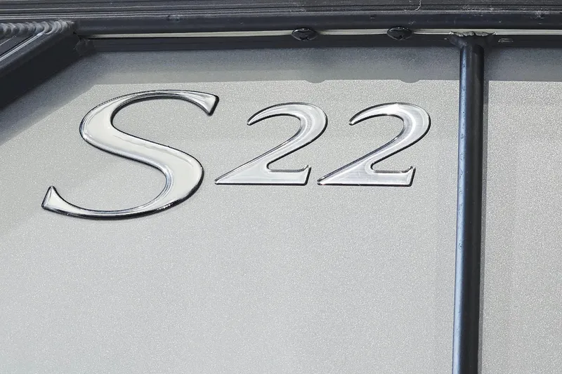 Slide: The Image of 2024 Bennington 22 S SWINGBACK emblem on metallic surface. - 21