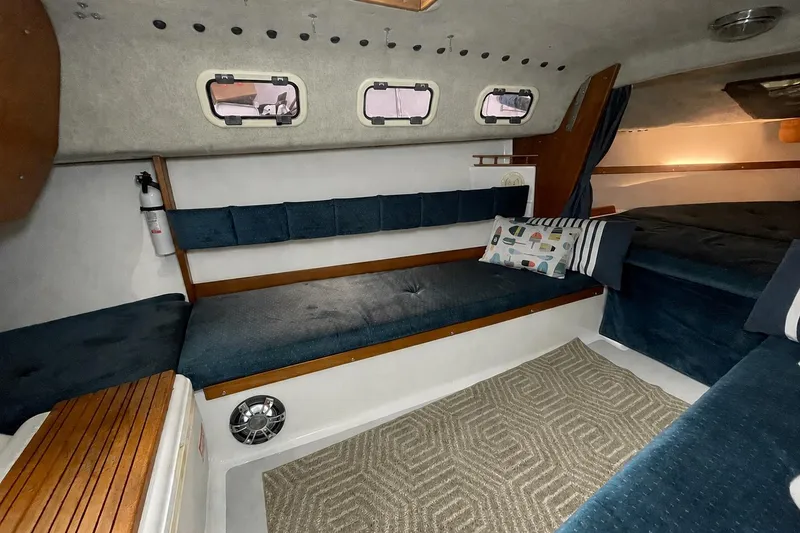 Slide: The Image of Interior of a 2001 Precision 23 sailboat with cozy seating and nautical decor. - 11
