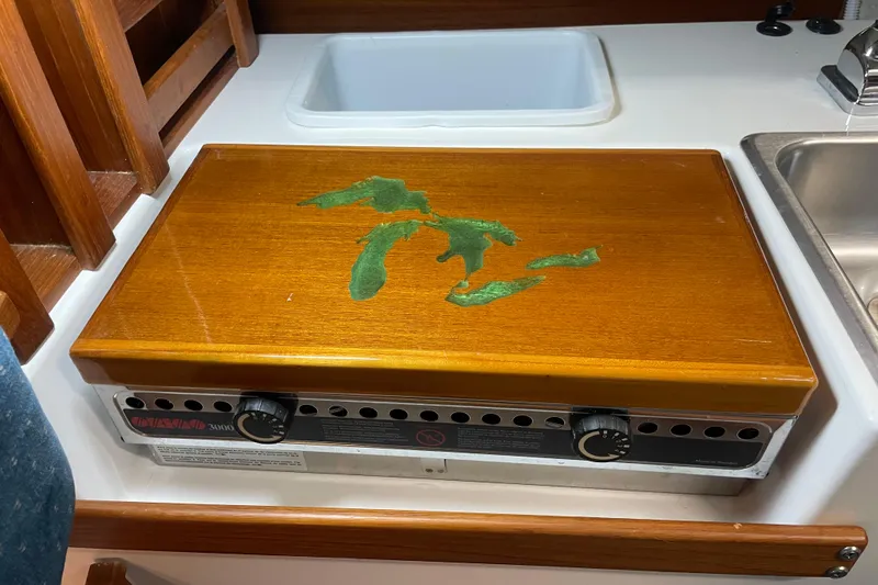 Slide: The Image of Wooden stove cover with Great Lakes design on a Precision 23 boat, 2001 model. - 17