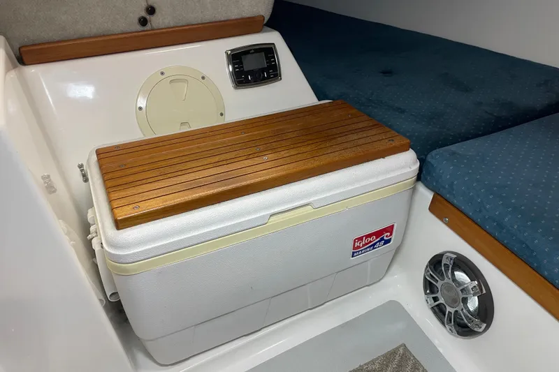 Slide: The Image of Interior of a 2001 Precision 23 boat with Igloo Marine cooler and wooden seating. - 22