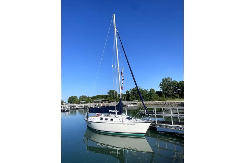 Slide: The Image of Sailboat docked on calm water, Precision 23 model, 2001, under clear blue sky. - 23