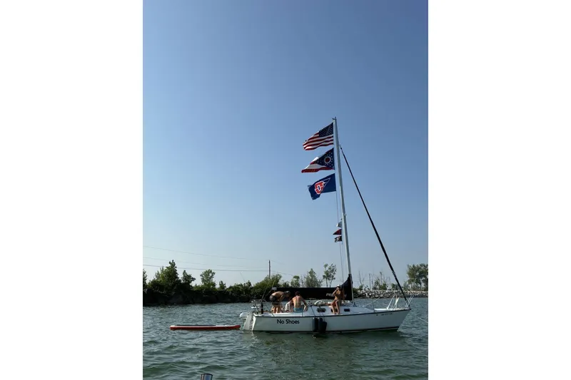 Slide: The Image of Sailboat "No Shoes" on water, flying multiple flags, clear sky, Precision 23 model, 2001. - 29