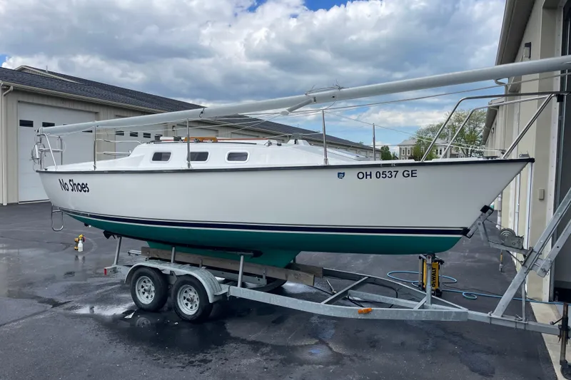 Slide: The Image of Sailboat "No Shoes" on trailer, Precision 23 model, 2001, parked near buildings. - 33