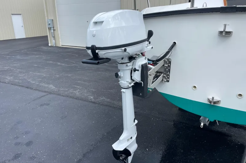 Slide: The Image of Outboard motor on a Precision 23 boat, 2001 model, parked on asphalt. - 36