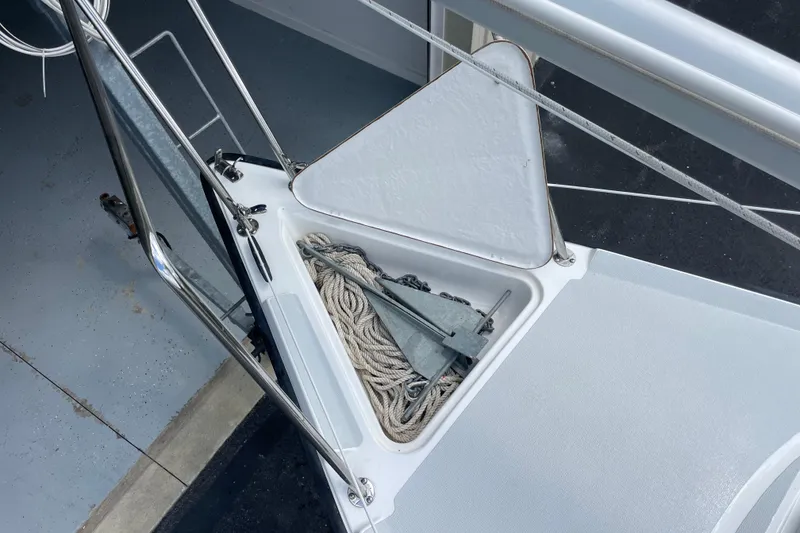 Slide: The Image of Open anchor locker on a 2001 Precision 23 sailboat, showing ropes and anchor. - 38