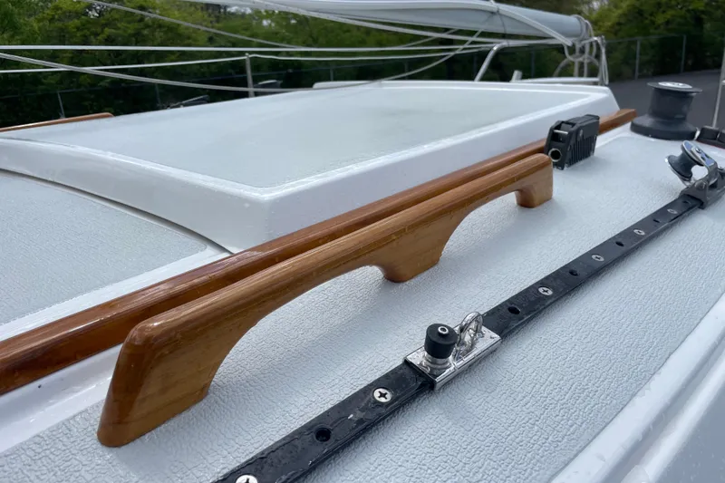 Slide: The Image of Close-up of a 2001 Precision 23 sailboat deck with wooden handrails and rigging. - 39