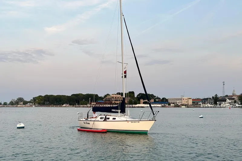Slide: The Image of 2001 Precision 23 sailboat on calm water near coastal town. - 4