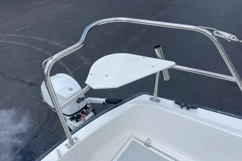 Slide: The Image of 2001 Precision 23 boat with stainless steel railing and outboard motor. - 44