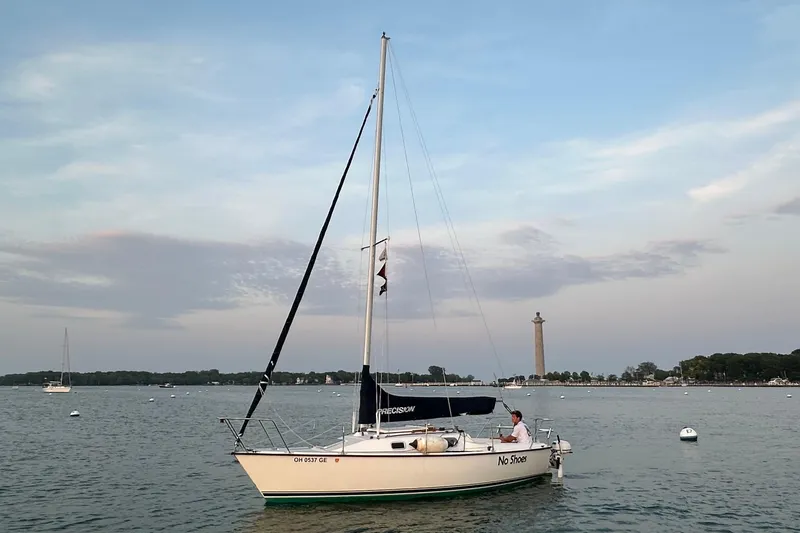 Slide: The Image of Sailboat "No Shoes" on calm water, Precision 23 model, 2001, with scenic background. - 5