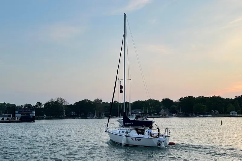 Slide: The Image of 2001 Precision 23 sailboat on calm water at sunset. - 6