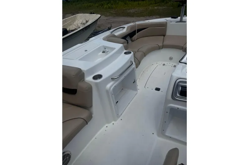 Slide: The Image of 2016 Hurricane SunDeck Sport 203 OB interior with beige seating and white deck. - 10