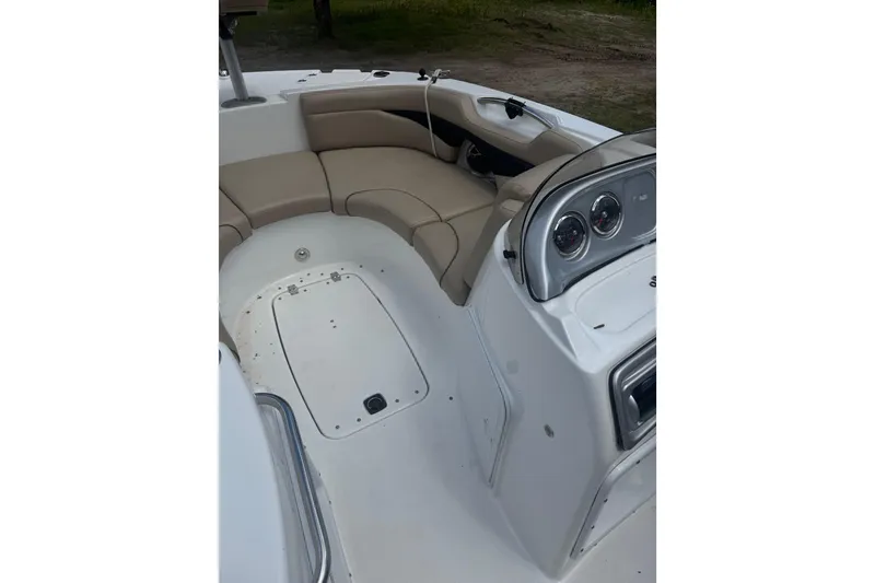 Slide: The Image of 2016 Hurricane SunDeck Sport 203 OB boat interior with beige seating and dashboard. - 11