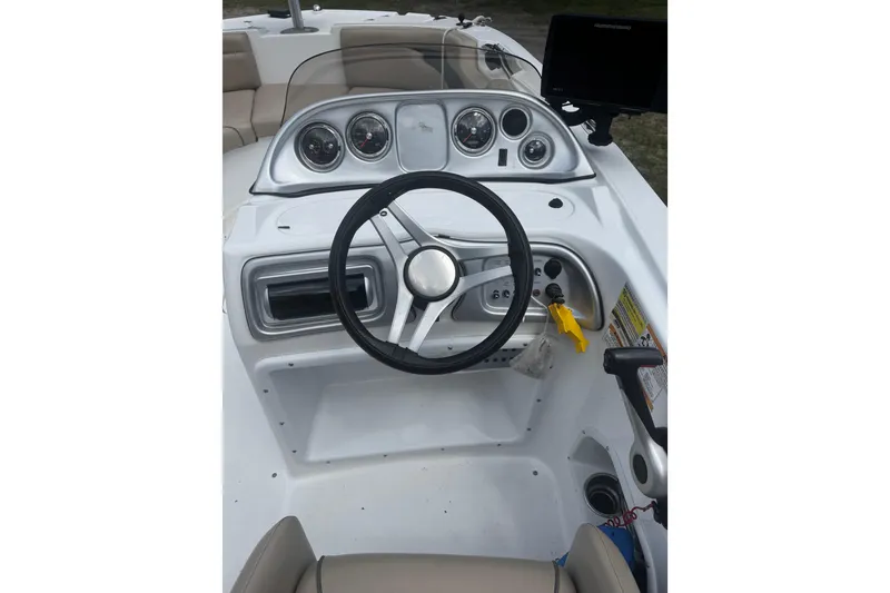 Slide: The Image of 2016 Hurricane SunDeck Sport 203 OB boat dashboard with steering wheel and gauges. - 12