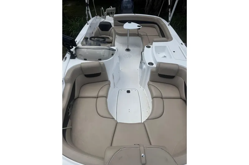 Slide: The Image of 2016 Hurricane SunDeck Sport 203 OB boat interior with beige seating and white deck. - 14