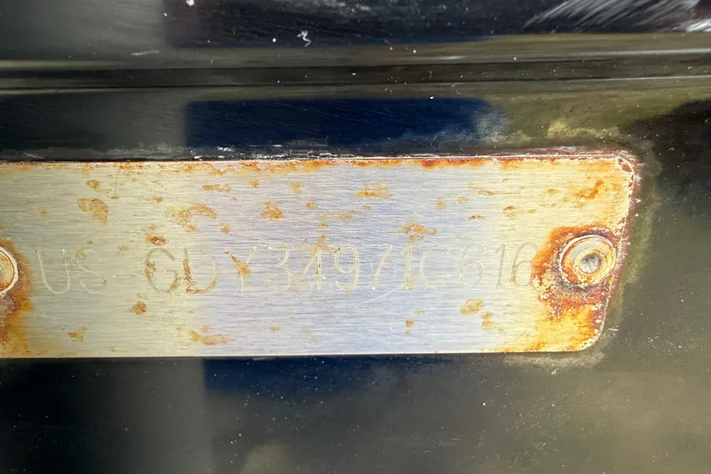 Slide: The Image of Rusty metal plate with engraved serial number on 2016 Hurricane SunDeck Sport 203 OB boat. - 16