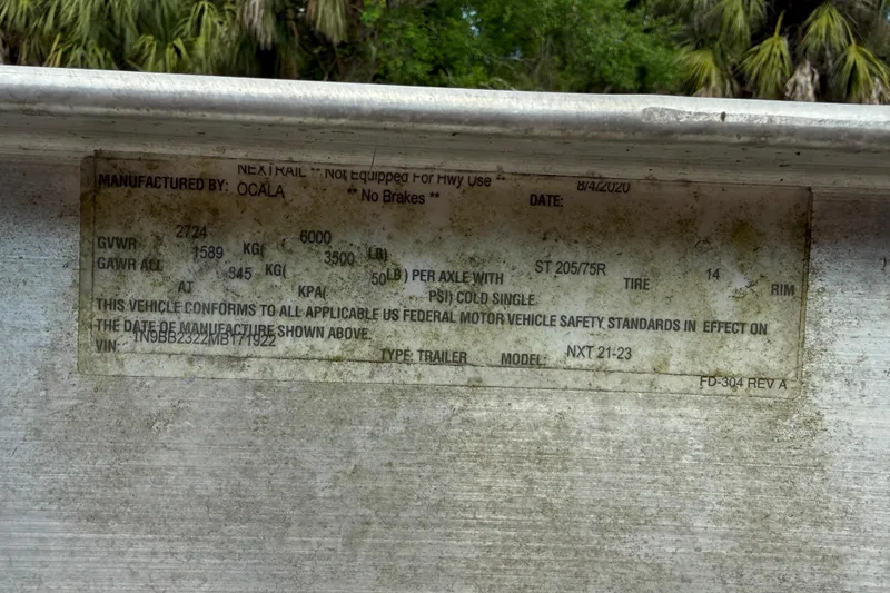 Slide: The Image of Label on a 2016 Hurricane SunDeck Sport 203 OB, detailing vehicle specifications and safety standards. - 18