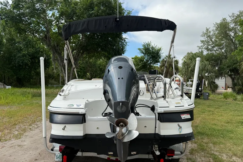 Slide: The Image of 2016 Hurricane SunDeck Sport 203 OB boat with outboard motor, parked on grass. - 4