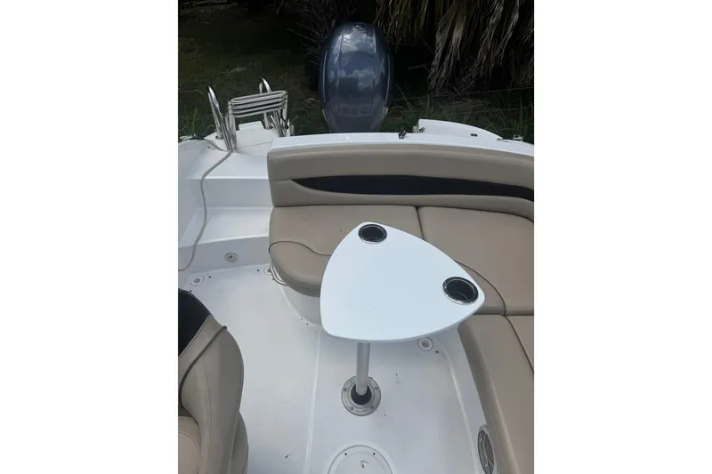 Slide: The Image of 2016 Hurricane SunDeck Sport 203 OB boat interior with seating and table. - 8