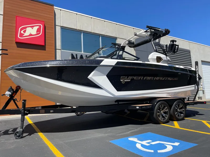 Slide: The Image of 2020 Nautique G23 boat parked in front of a building. - 2