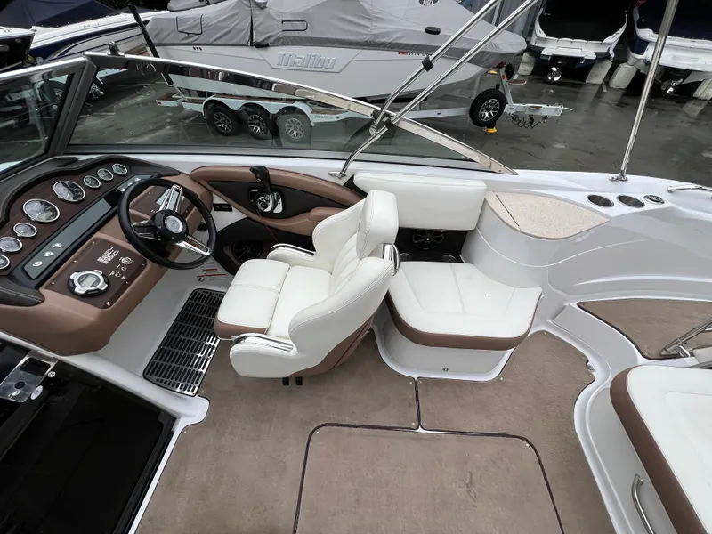 Slide: The Image of Interior of a 2014 Cobalt 243 boat with white seating and dashboard. - 12